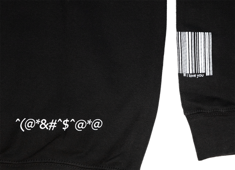 Extreme close up of back print detail and sleeve. Random symbols and UPC barcode printed on sleeve with text I love you.
