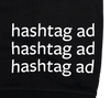 Extreme close up of back bottom hem. Hashtag ad 3 times print detail.