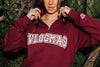 Close up of Alisha Marie wearing Maroon Vlogmas 2021 Quarter Zip Sweatshirt. Screen print front and sleeve in color cream.